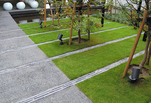 Displaying roof tiles of the Old Office in a line on the lawn patio