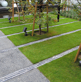 Displaying roof tiles of the Old Office in a line on the lawn patio